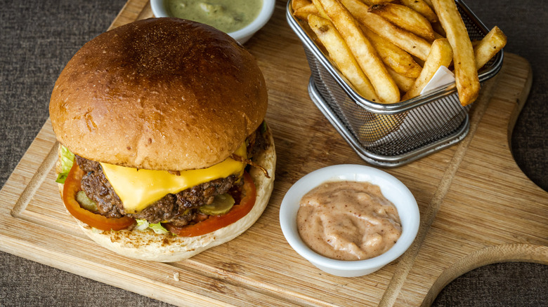 burger and fries with side of sauce